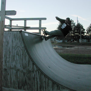 Skateboarding photograph of Sebastian Aravena doing a 5-O grind on a halfpipe in Stratford Wisconsin. Photograph by Colleen Aravena.