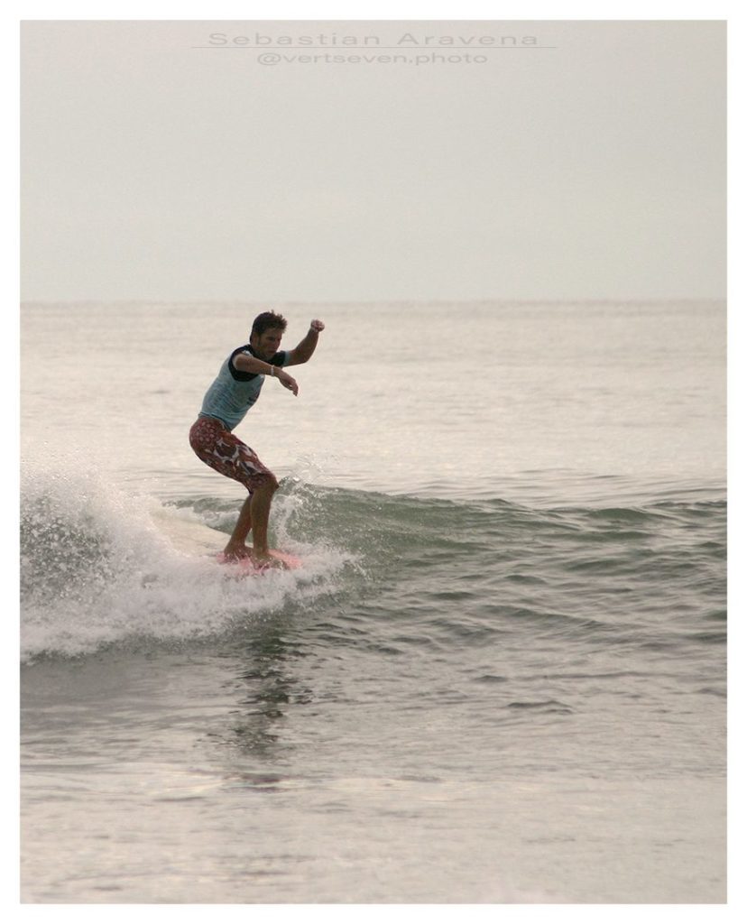 Photograph of a surfer nose riding at the National Kidney Foundation contest in Cocoa Beach, Florida. Photography by Sebastian Aravena.